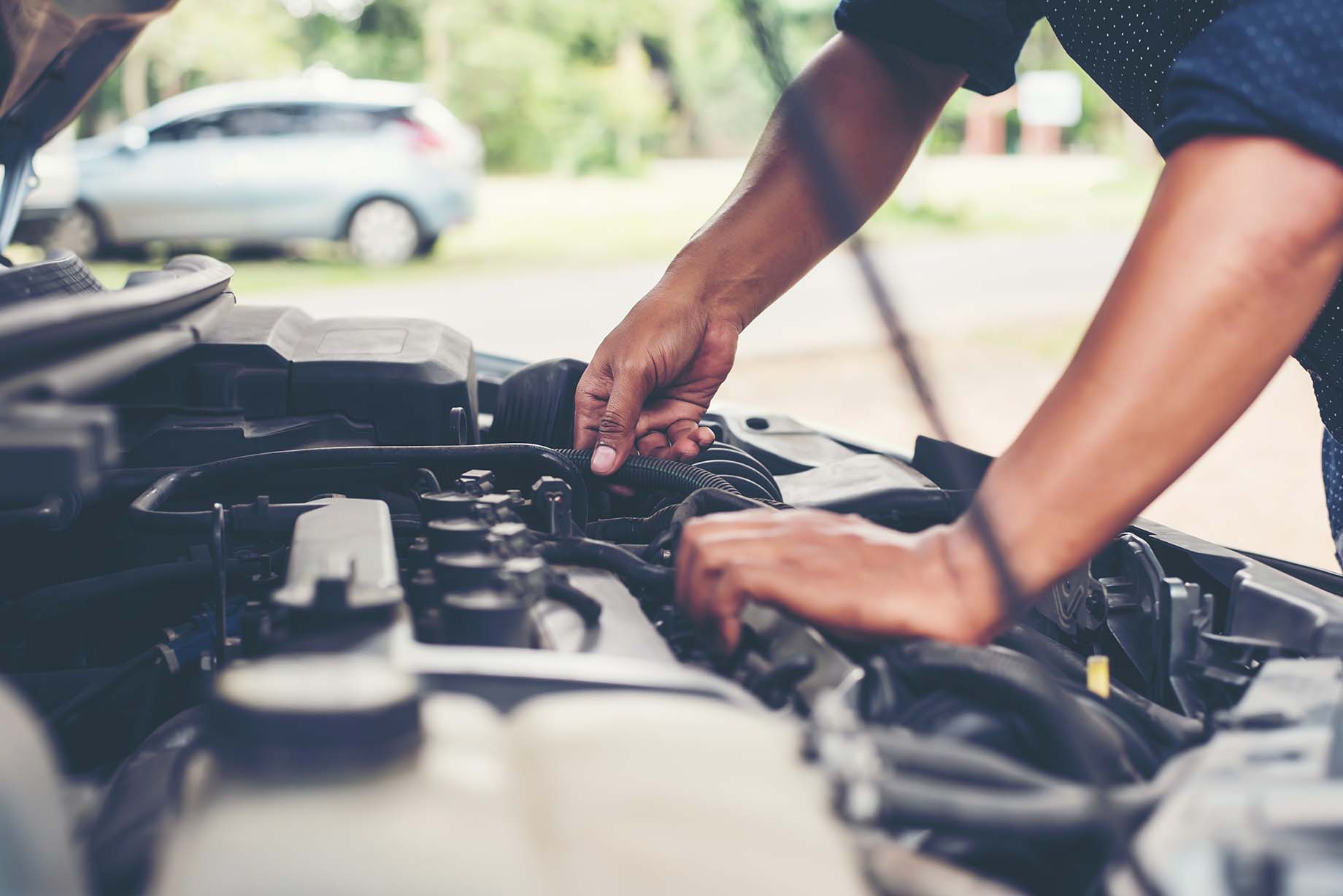 Mechanic inspecting a vehicle during routine maintenance services.