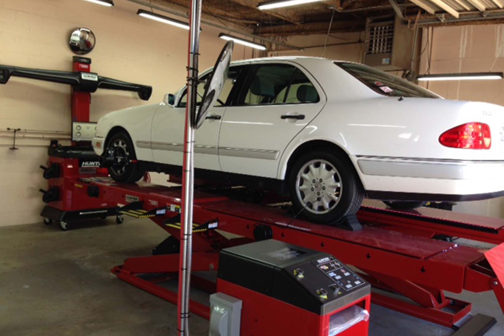 Car in an auto shop undergoing repair.