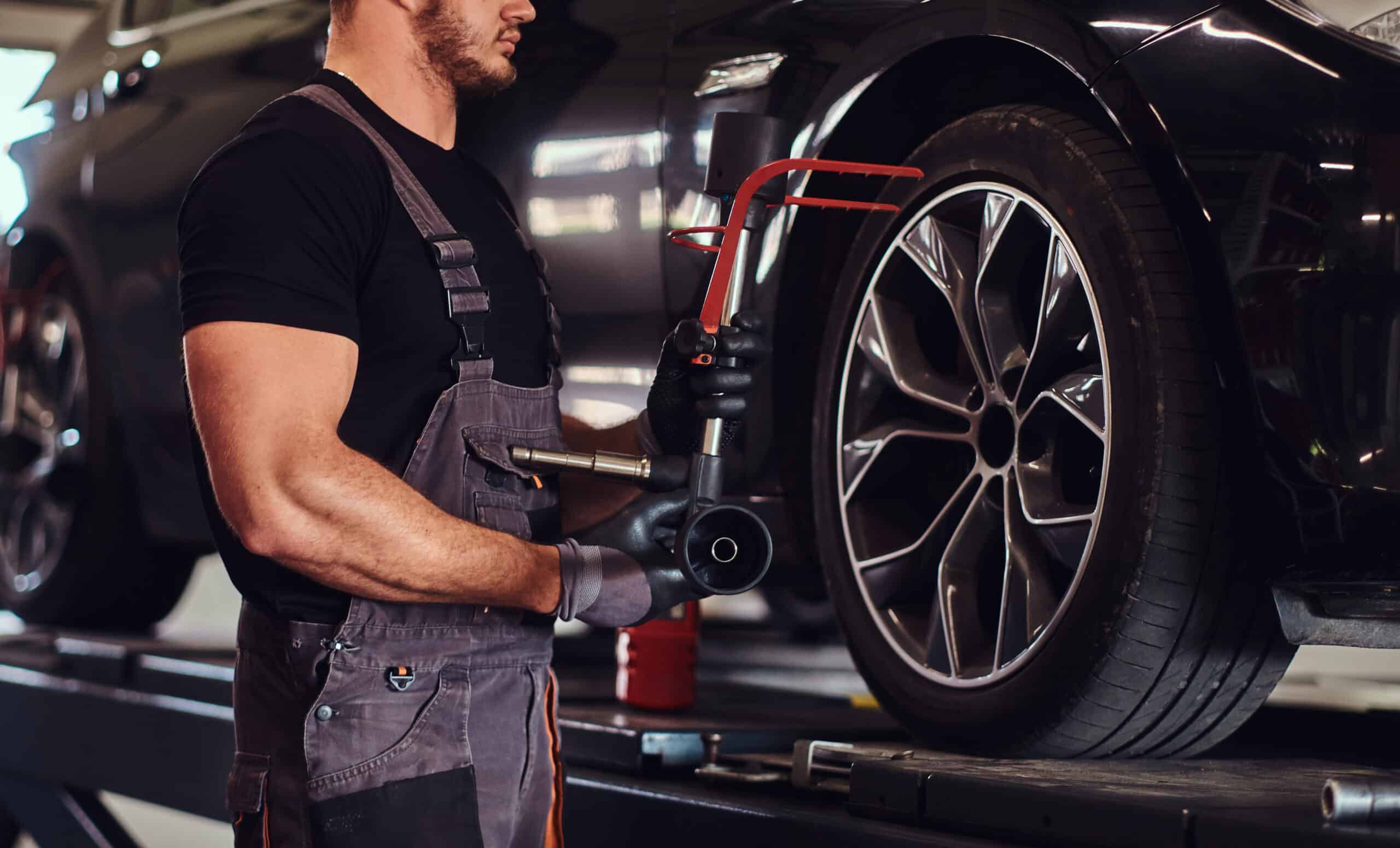Auto mechanic diligently addressing tire problems by repairing a car tire.