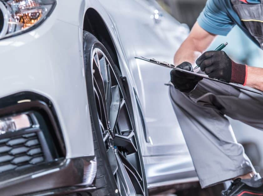 Auto mechanic performing car maintenance check
