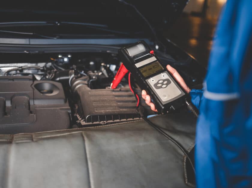 Skilled auto mechanic inspecting interstate batteries for optimal performance and reliability