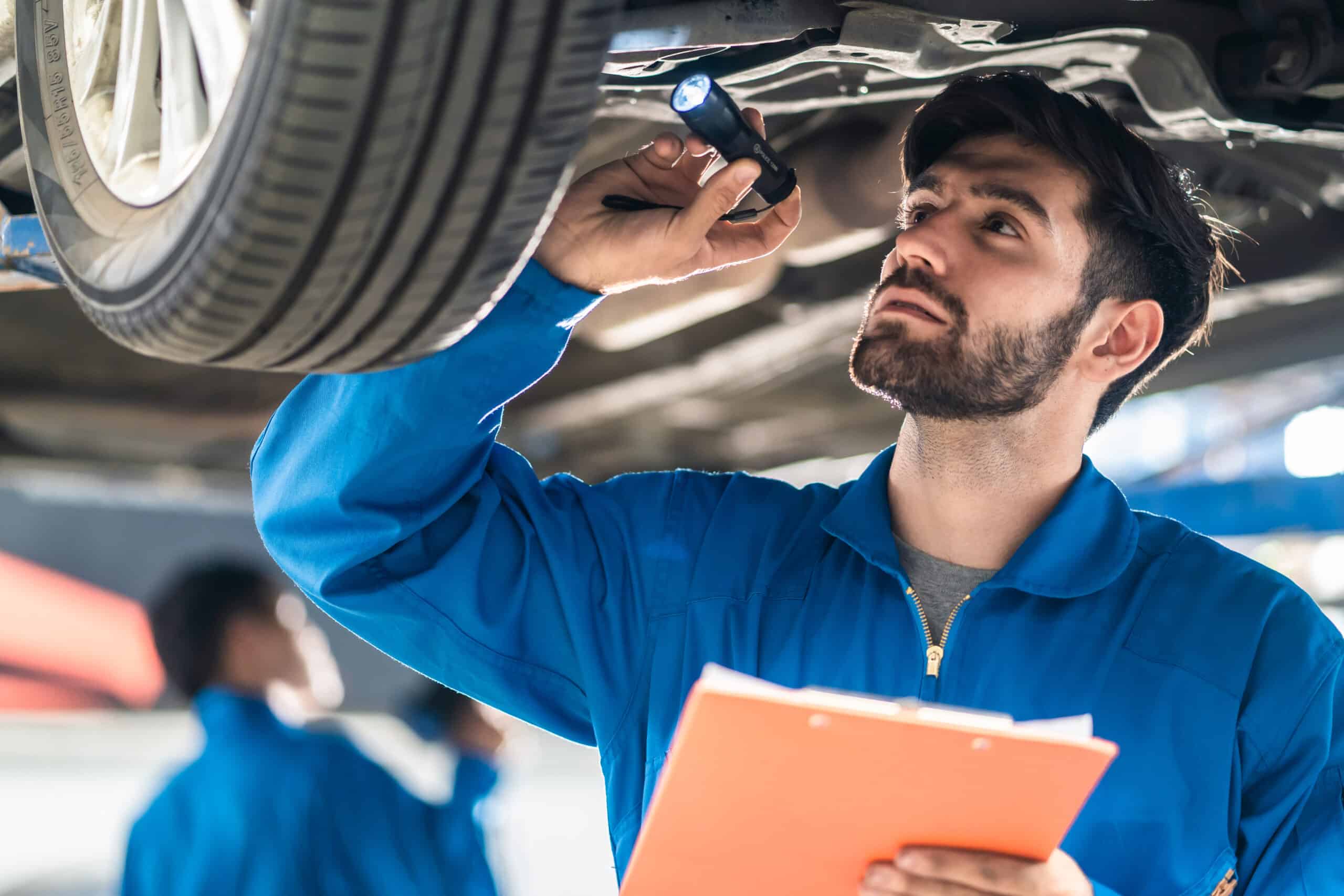 A mechanic performing car brake repair and maintenance during vehicle service, inspecting and maintaining the braking system for optimal safety and performance.