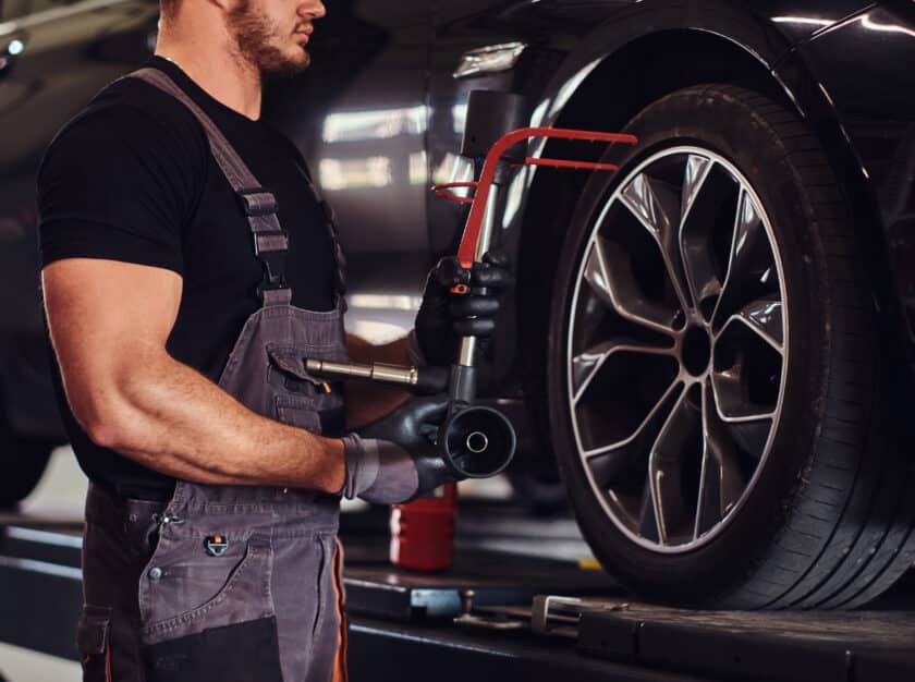 Auto mechanic diligently addressing tire problems by repairing a car tire